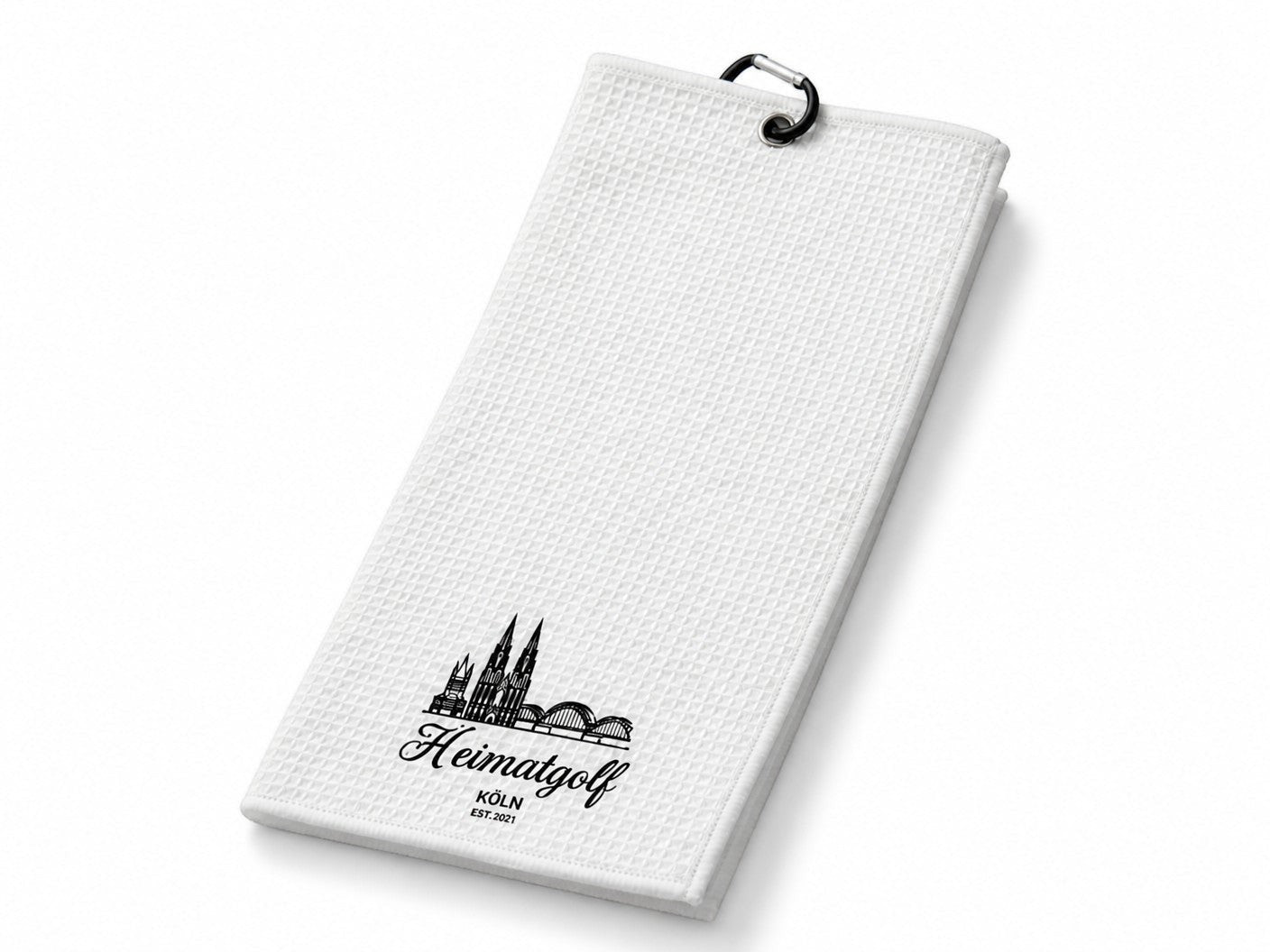 City Golf Shop Waffel-Golftuch in Weiß mit schwarzem Kölner Dom Motiv und Karabinerhaken für das Golfbag.